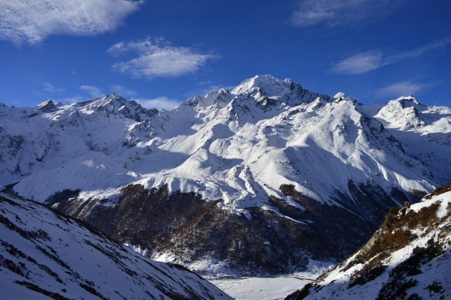 Snow-covered Himalayan mountain range with frozen valley in Nepal
